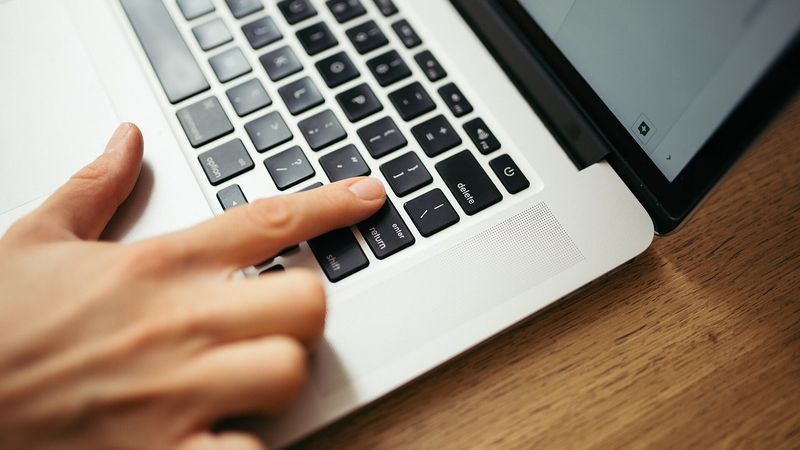 Hands on a laptop keyboard