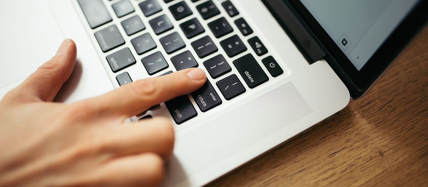 Hands on a laptop keyboard